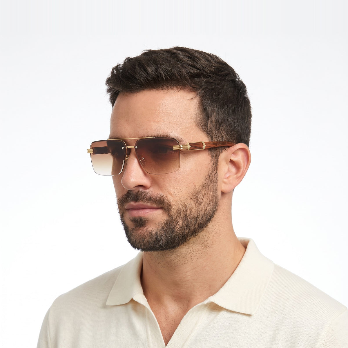 Man in a cream knit polo wearing Aspen rimless brown gradient sunglasses with gold bridge and wood-grain temples · Velezeco #opt1_1