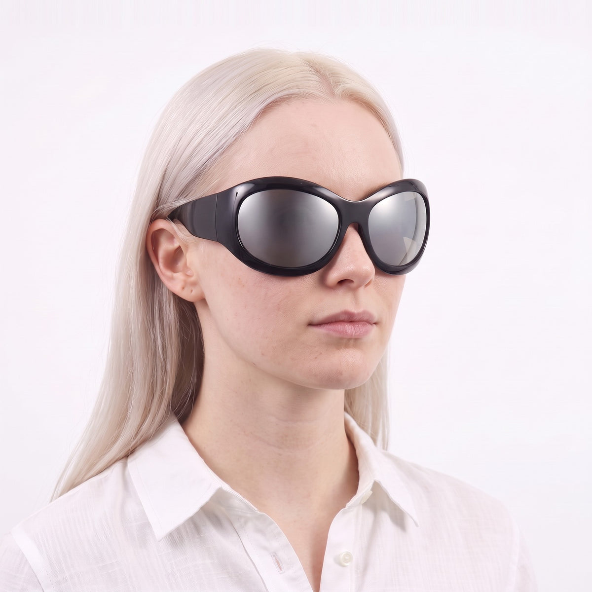 Woman in a white linen shirt wearing Barcelona bug-eye sunglasses with glossy black frame and silver mirror lenses — Velezeco #opt1_2