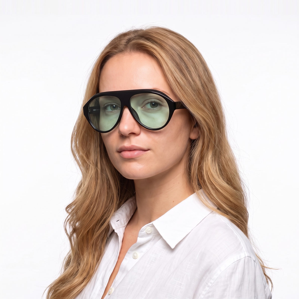 Woman in a white linen shirt wearing Boston black oversized aviator sunglasses with light green lenses · Velezeco #opt1_5