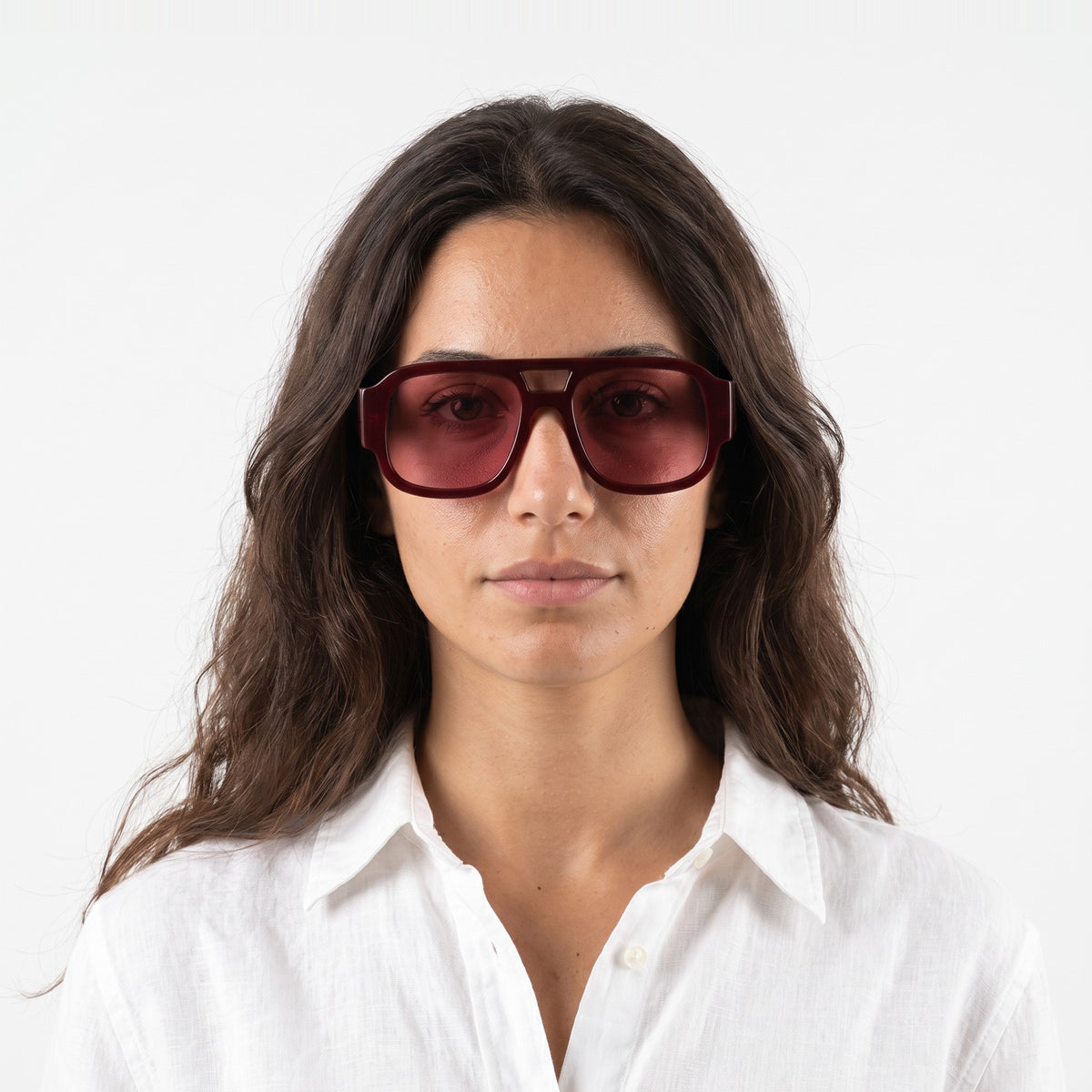 Woman in a white linen shirt wearing Crimson oversized square aviator sunglasses in Red with pink lenses - Velezeco #opt1_1