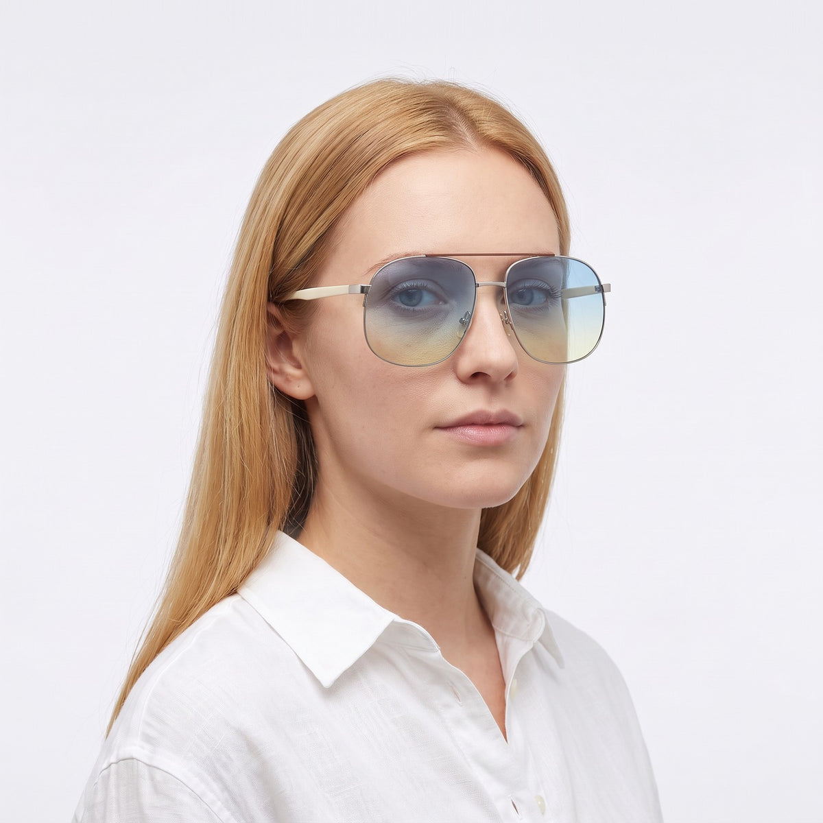 Woman in a white linen shirt wearing Dubai aviator sunglasses with silver double bridge and blue-to-yellow gradient lenses — Velezeco #opt1_7
