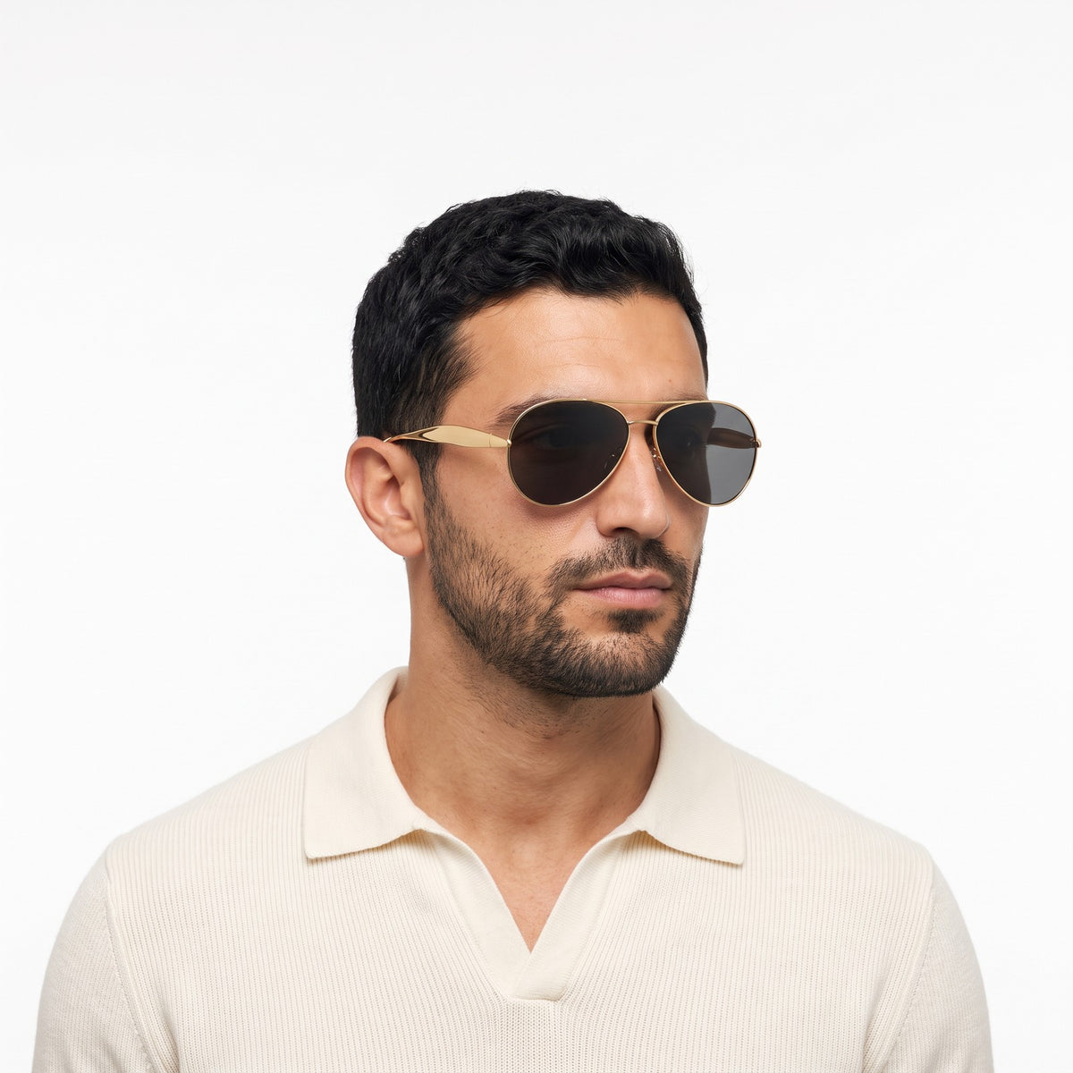 Man in a cream knit polo wearing Duna gold aviator sunglasses with black lenses · Velezeco #opt1_3