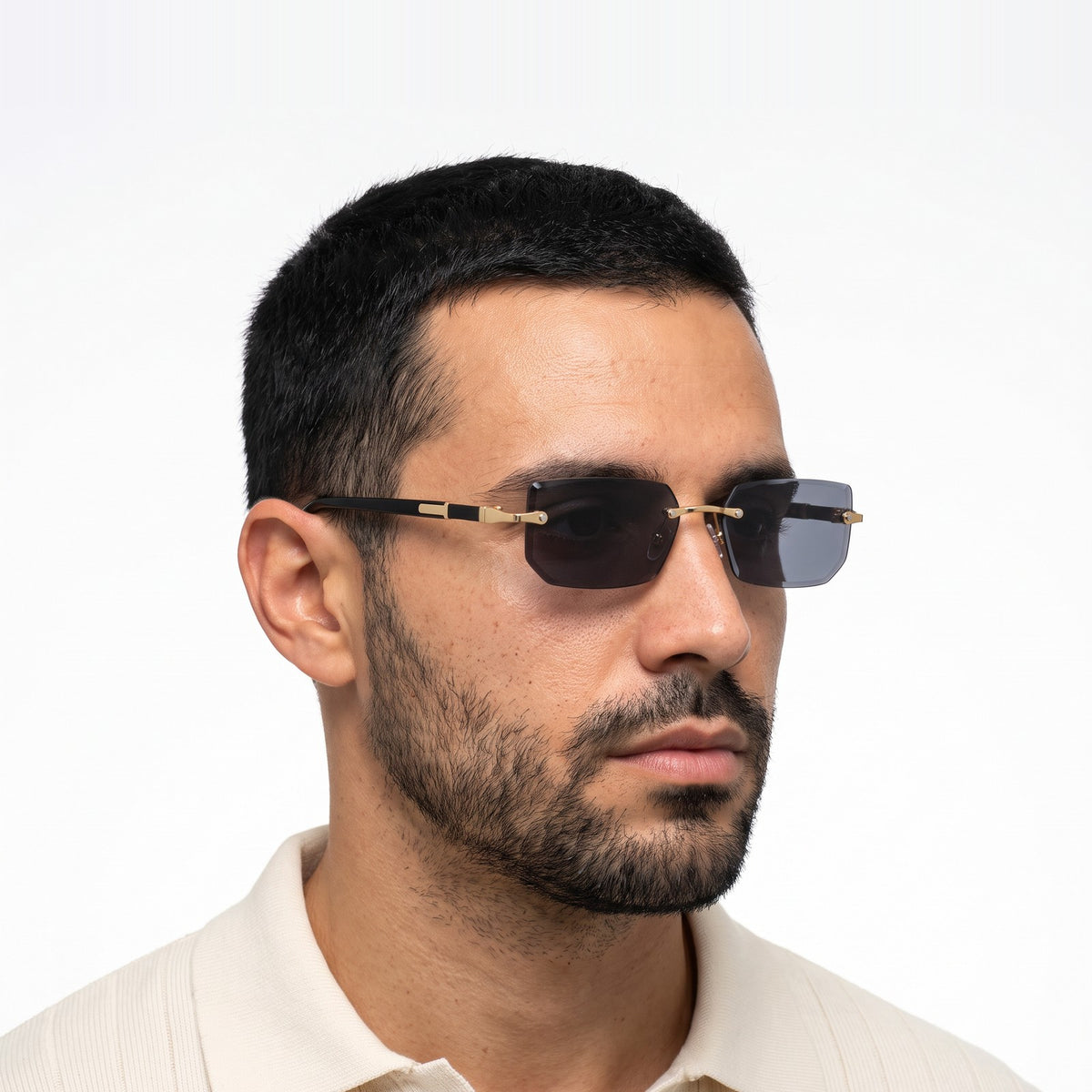 Man in a cream knit polo wearing Hills rimless rectangular sunglasses with black lenses · Velezeco #opt1_4