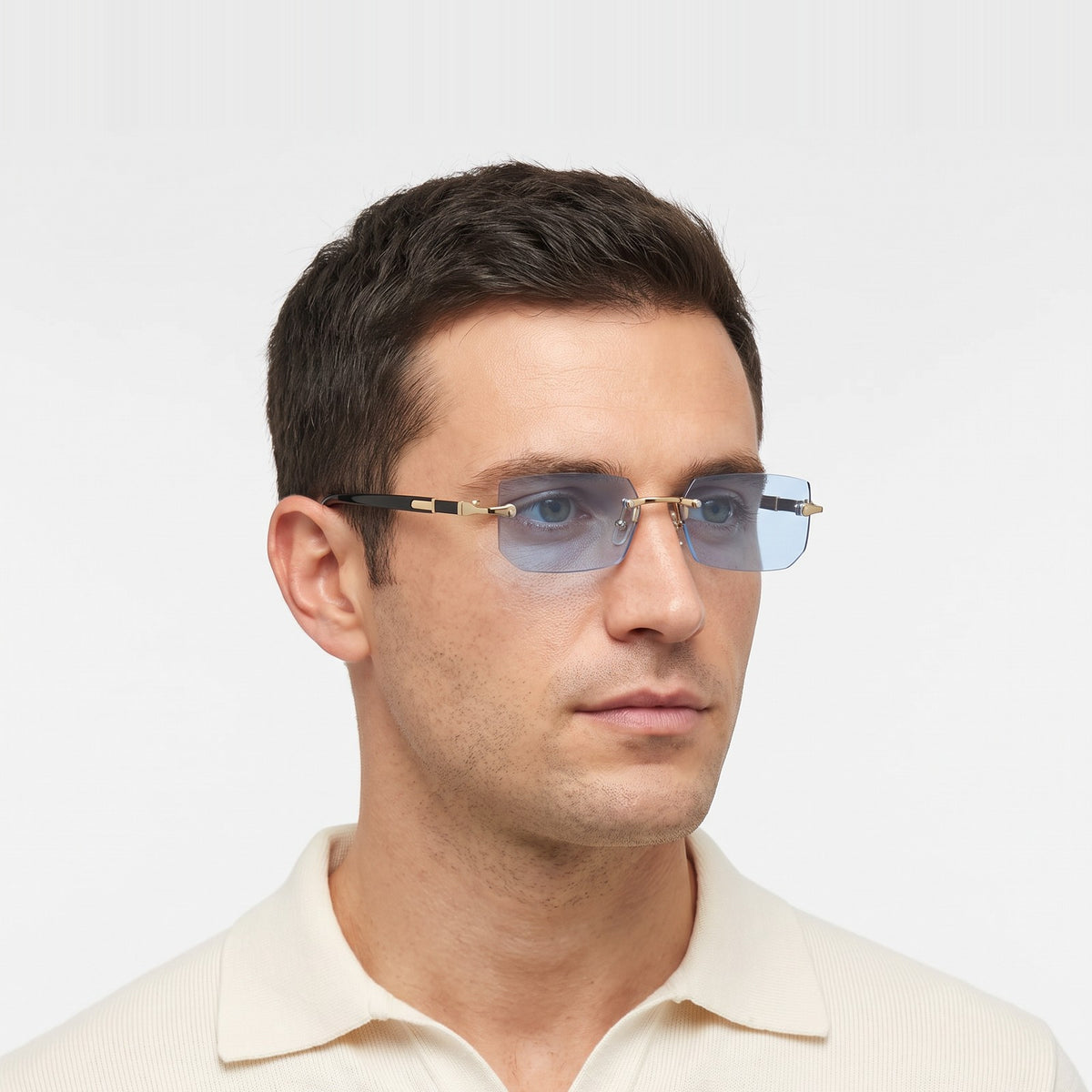 Man in a cream knit polo wearing Hills rimless rectangular sunglasses with light blue lenses · Velezeco #opt1_2