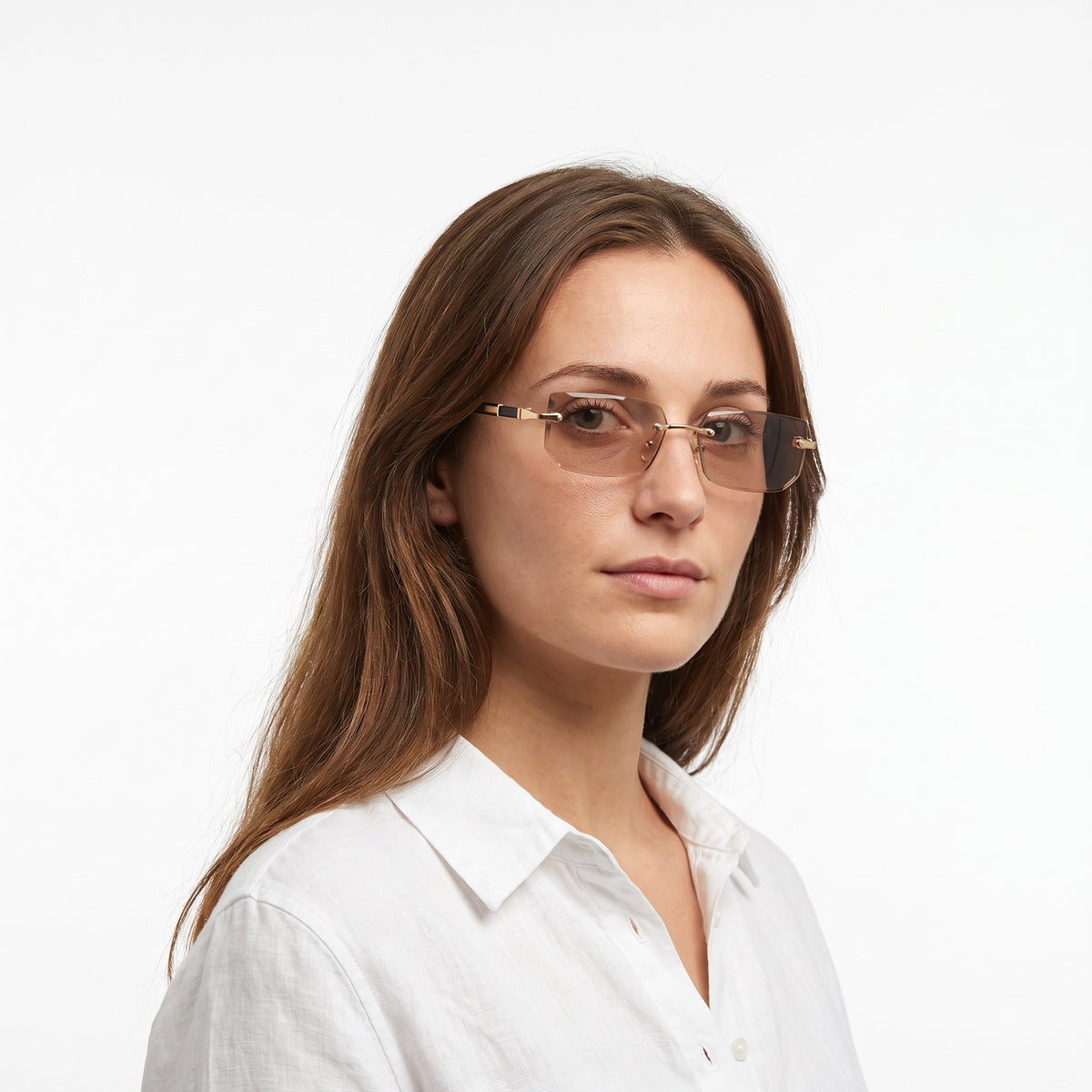 Woman in a white linen shirt wearing Hills rimless rectangular sunglasses with clear brown lenses · Velezeco #opt1_1