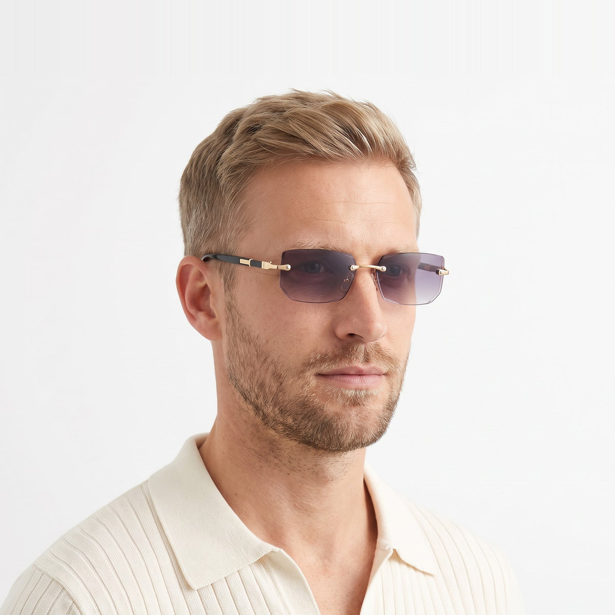 Man in a cream knit polo wearing Hills rimless rectangular sunglasses with grey gradient lenses · Velezeco #opt1_3