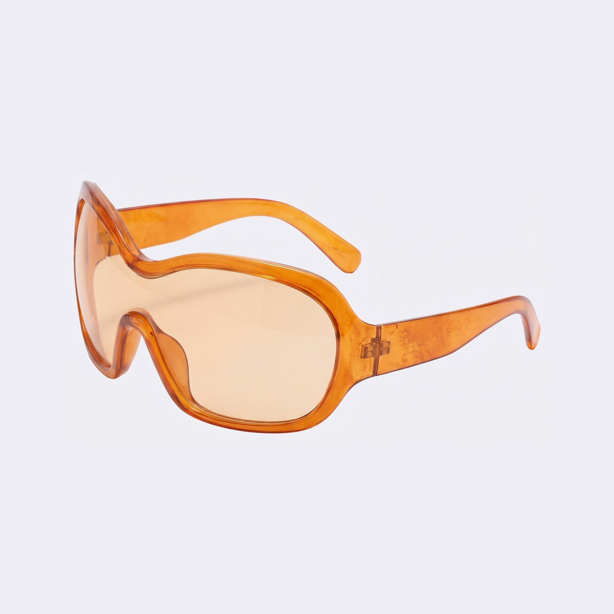 Three-quarter view of the Marrakech shield with translucent orange frame and amber lens and wavy brow line — Velezeco #opt1_2