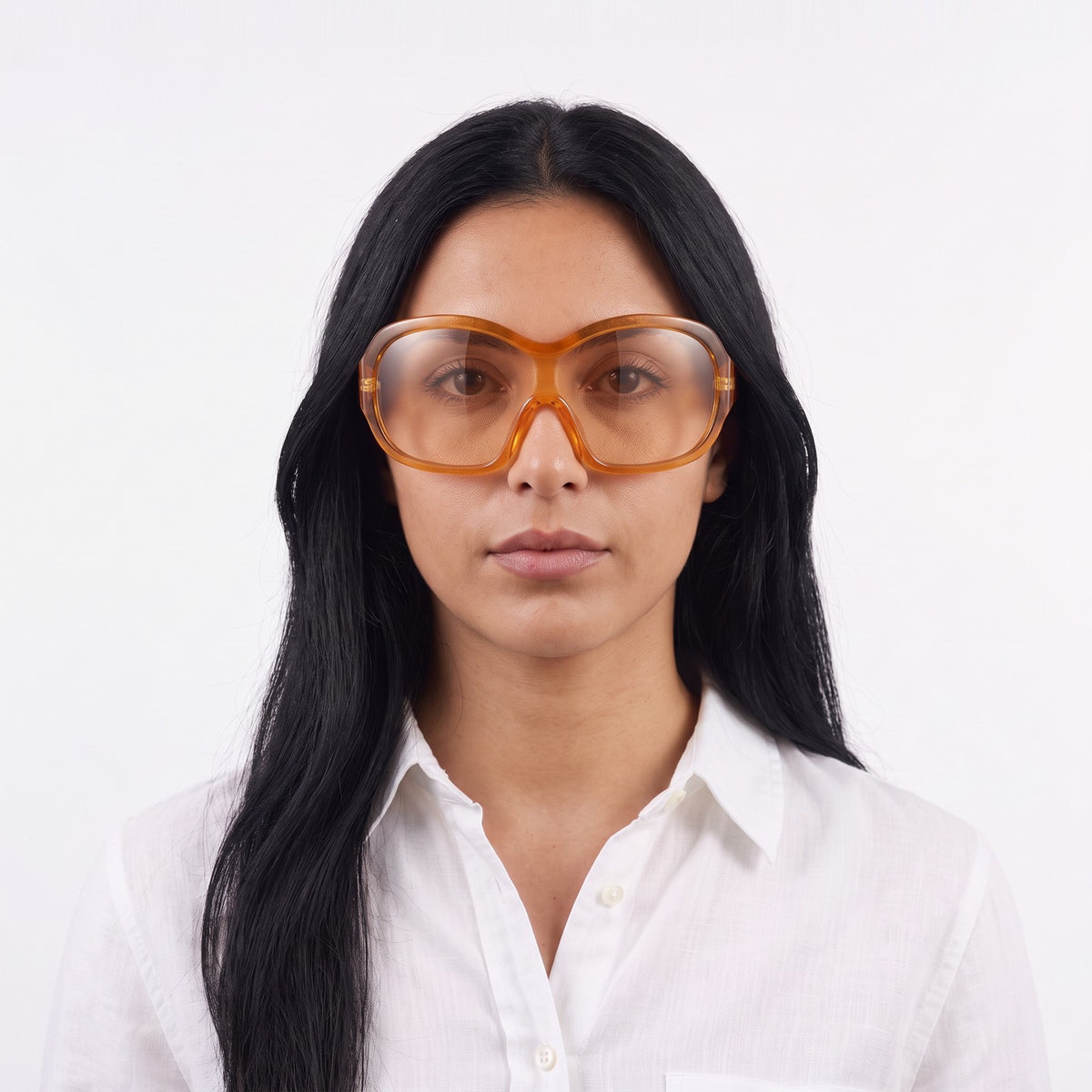 Woman in a white linen shirt wearing Marrakech shield sunglasses with translucent orange frame and amber lens — Velezeco #opt1_2