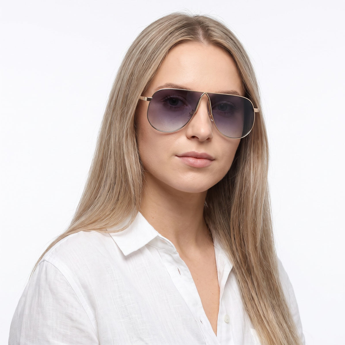 Woman in a white linen shirt wearing Mirage oversized gold shield aviator sunglasses with grey gradient lenses, Double Gray · Velezeco #opt1_2