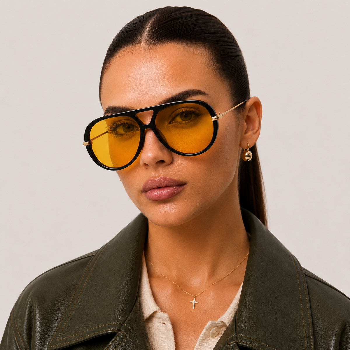 Woman wearing The Nimbus oversized black aviator sunglasses with yellow lenses and gold metal temples by Velezeco. #opt1_1
