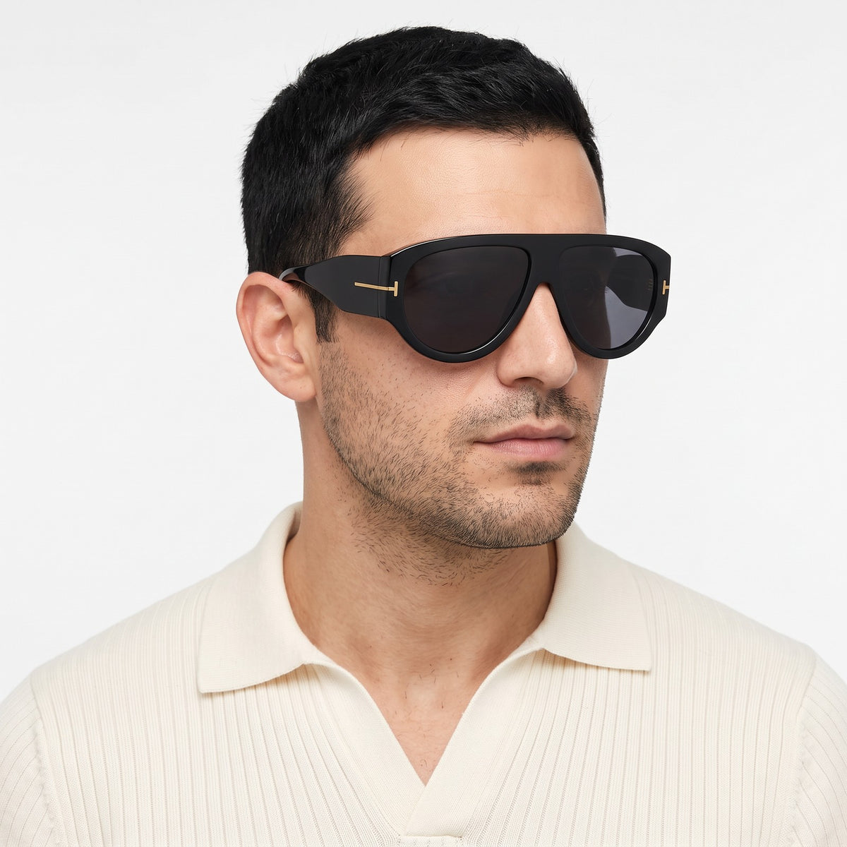 Man in a cream knit polo wearing VELEZECO Veneza black oversized aviator sunglasses with black lenses · Black #opt1_3