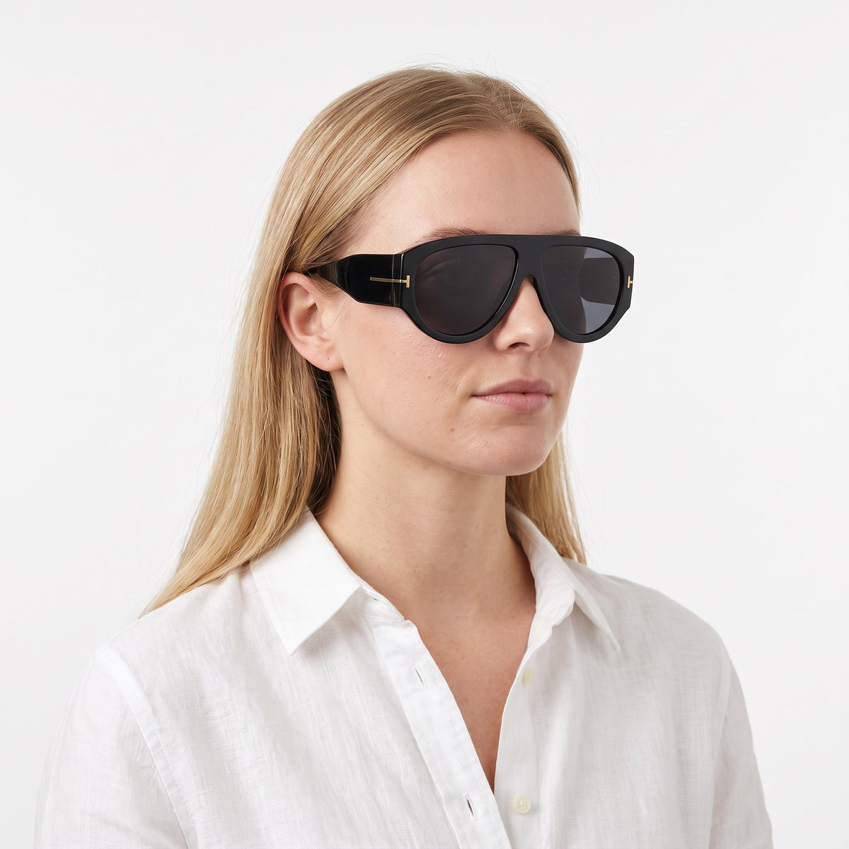 Woman in a white linen shirt wearing VELEZECO Veneza black oversized aviator sunglasses with black lenses · Black #opt1_3