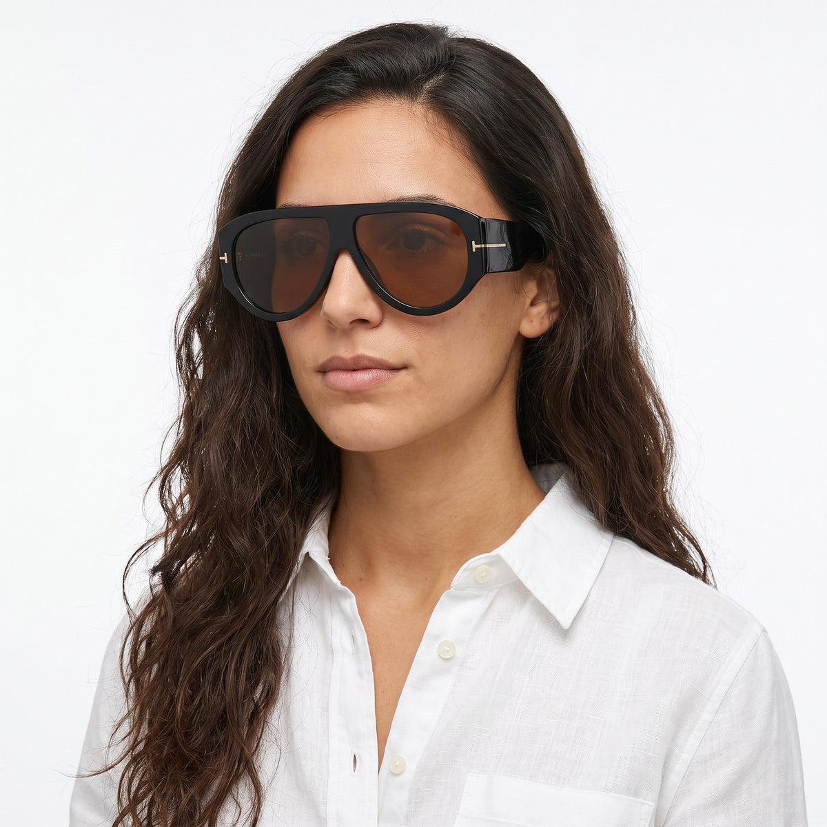 Woman in a white linen shirt wearing VELEZECO Veneza black oversized aviator sunglasses with brown lenses · Brown #opt1_1