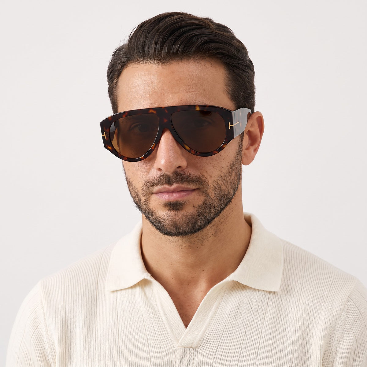Man in a cream knit polo wearing VELEZECO Veneza tortoiseshell oversized aviator sunglasses with brown lenses · Tortoiseshell #opt1_2