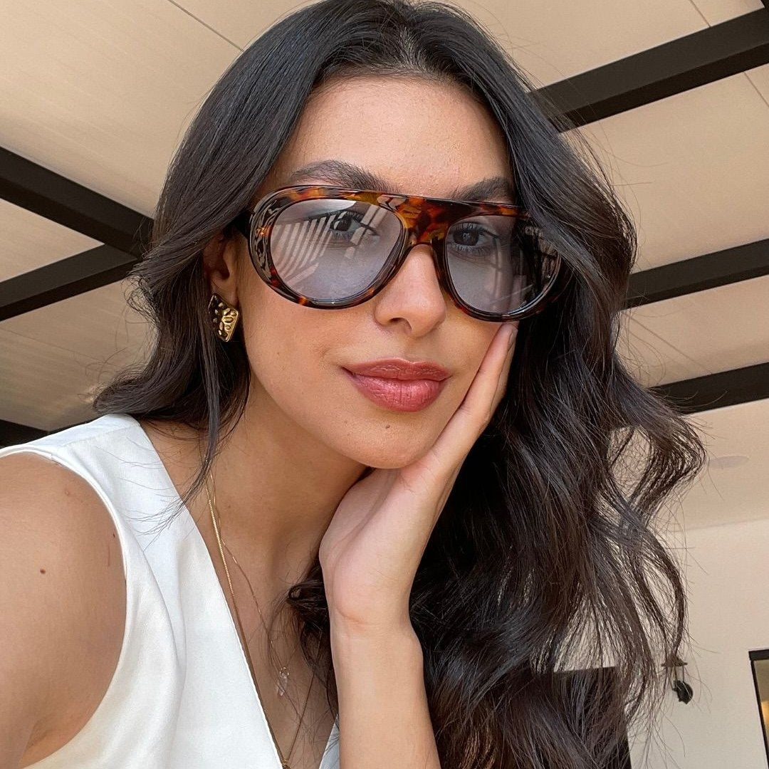 Oversized aviator sunglasses worn in the street