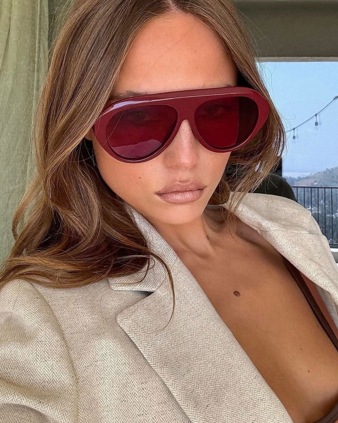 Woman wearing oversized aviator sunglasses