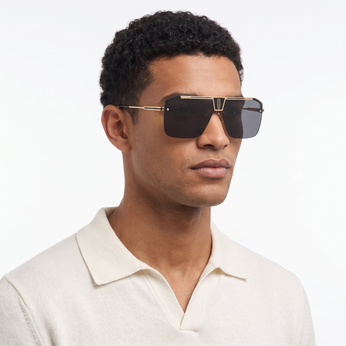 Man in an off-white knit polo wearing Alpine shield sunglasses with a dark smoke grey lens — Velezeco #opt1_2