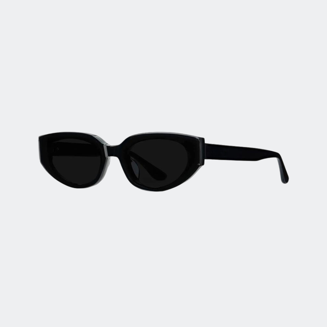 Cat eye sunglasses in glossy black with black lenses, angled view — Astra — Velezeco