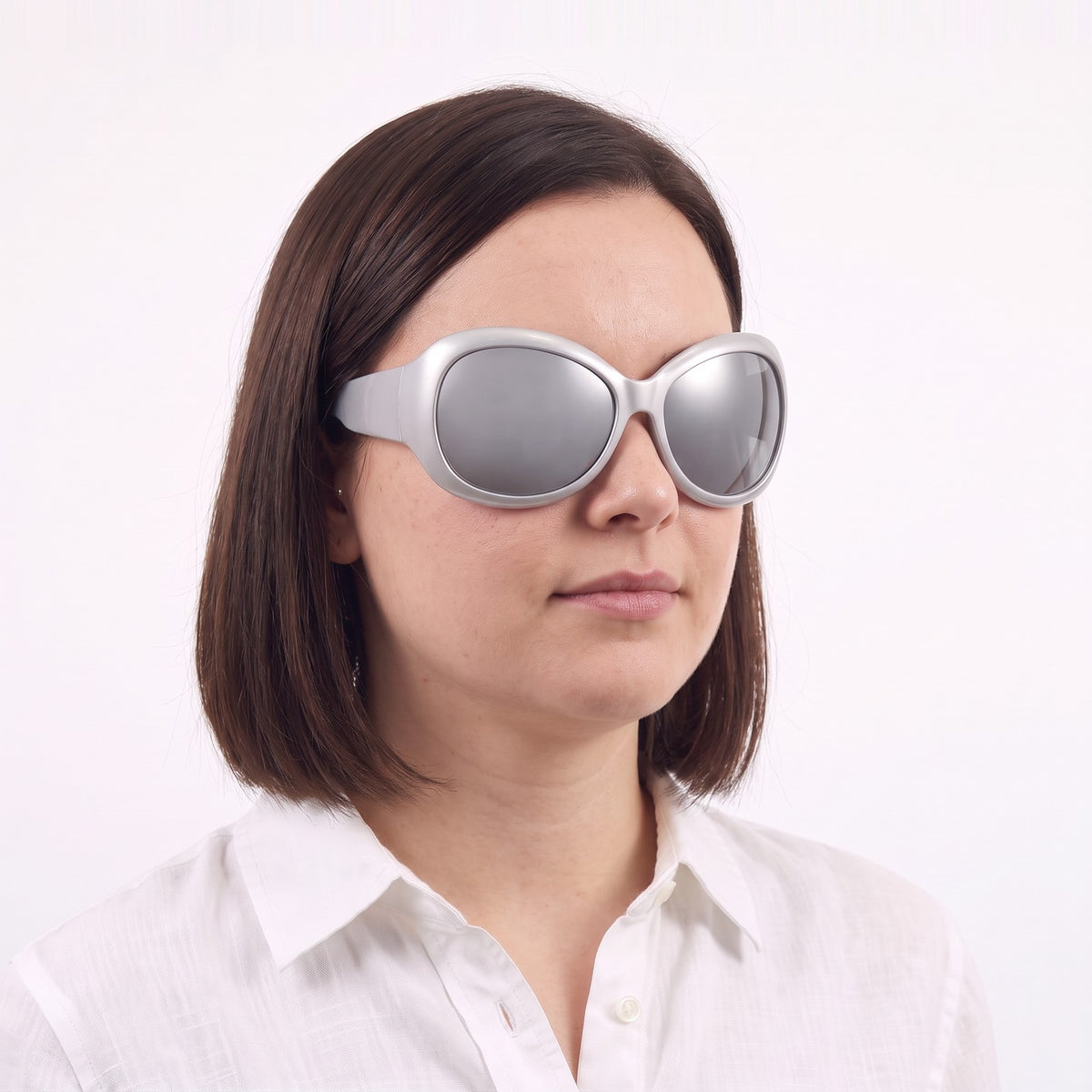 Woman in a white linen shirt wearing Barcelona bug-eye sunglasses with silver frame and silver mirror lenses — Velezeco #opt1_8