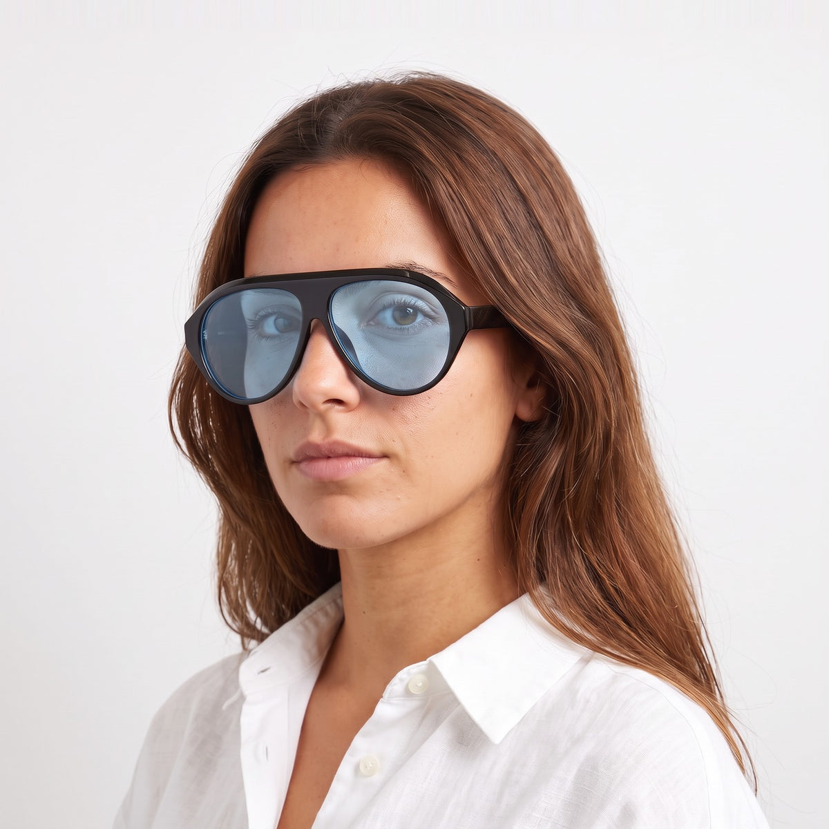 Woman in a white linen shirt wearing Boston black oversized aviator sunglasses with light blue lenses · Velezeco #opt1_4