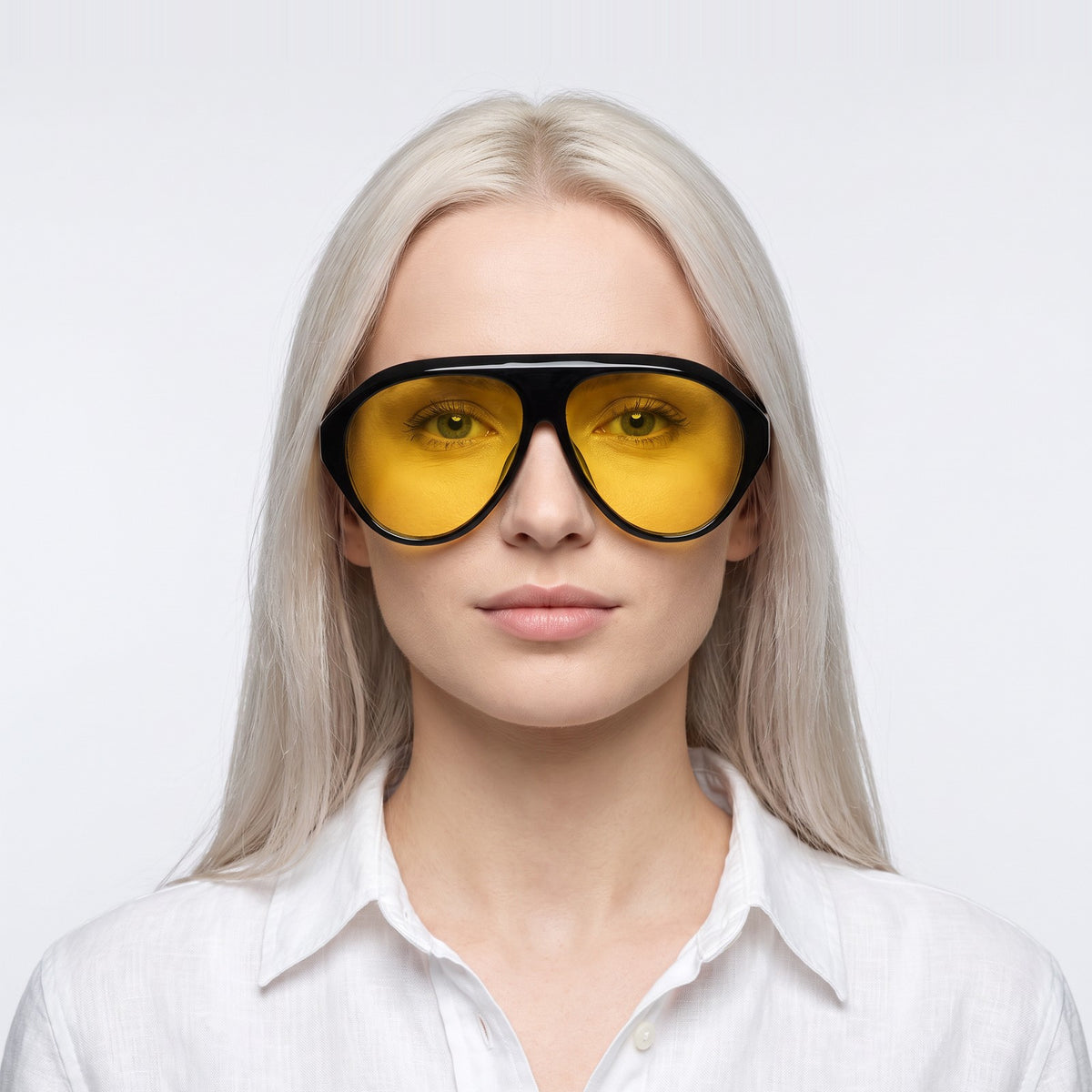 Woman in a white linen shirt wearing Boston black oversized aviator sunglasses with yellow lenses · Velezeco #opt1_3