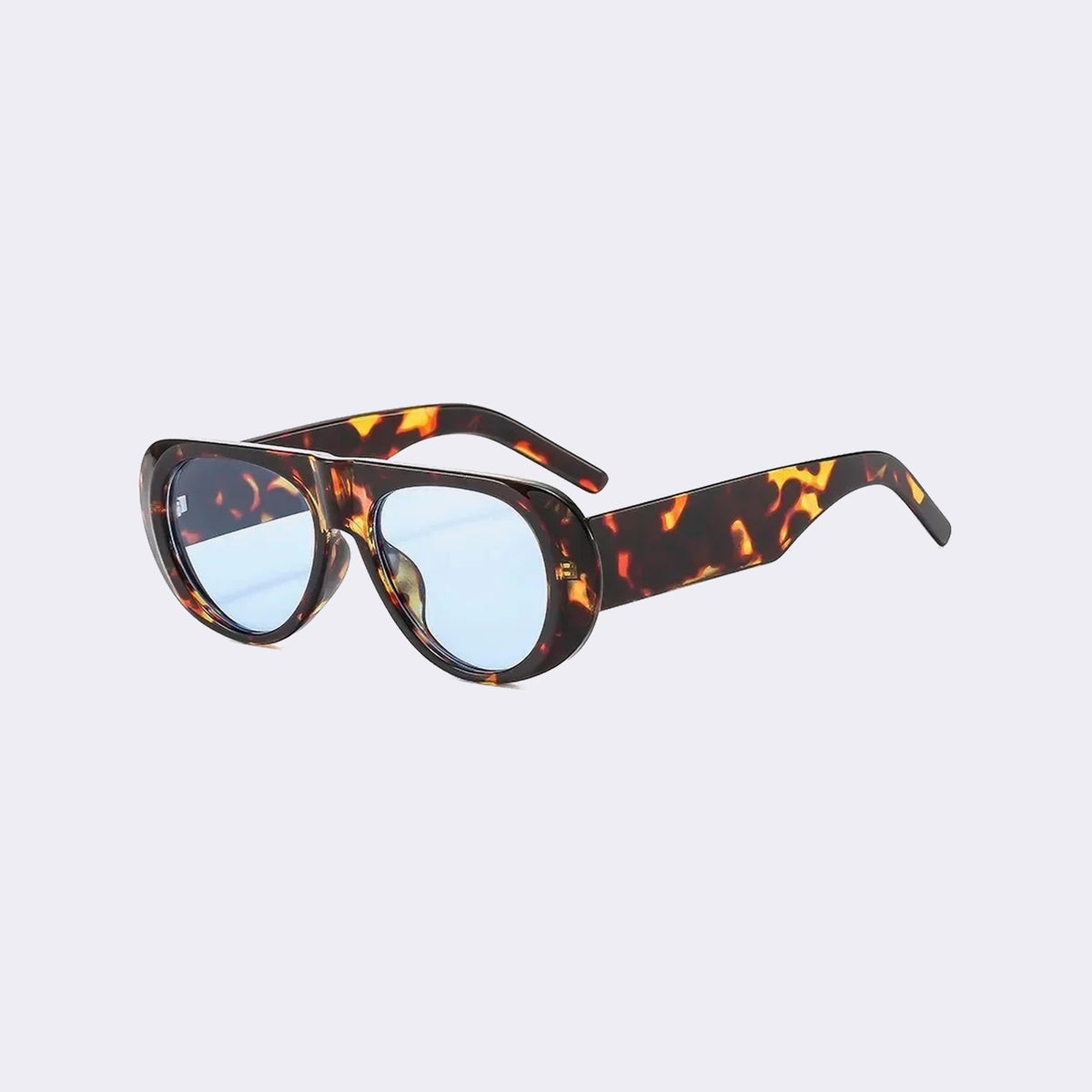 Three-quarter view of the Cortina with a tortoiseshell frame and pale blue lenses, showing the flared side shield — Velezeco #opt1_3