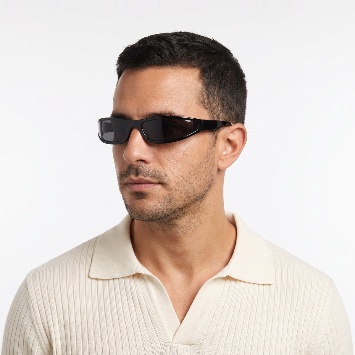 Man in a cream knit polo wearing Dax black wraparound sunglasses with dark grey lenses · Velezeco #opt1_1