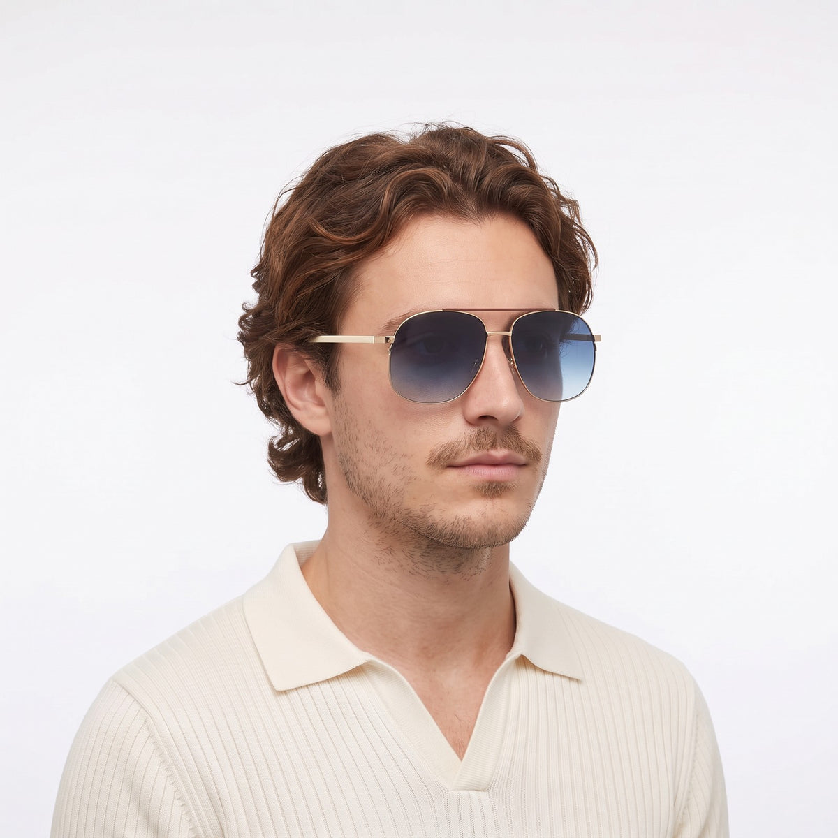Man in a cream knit polo wearing Dubai aviator sunglasses with gold double bridge and gradient blue lenses — Velezeco #opt1_5