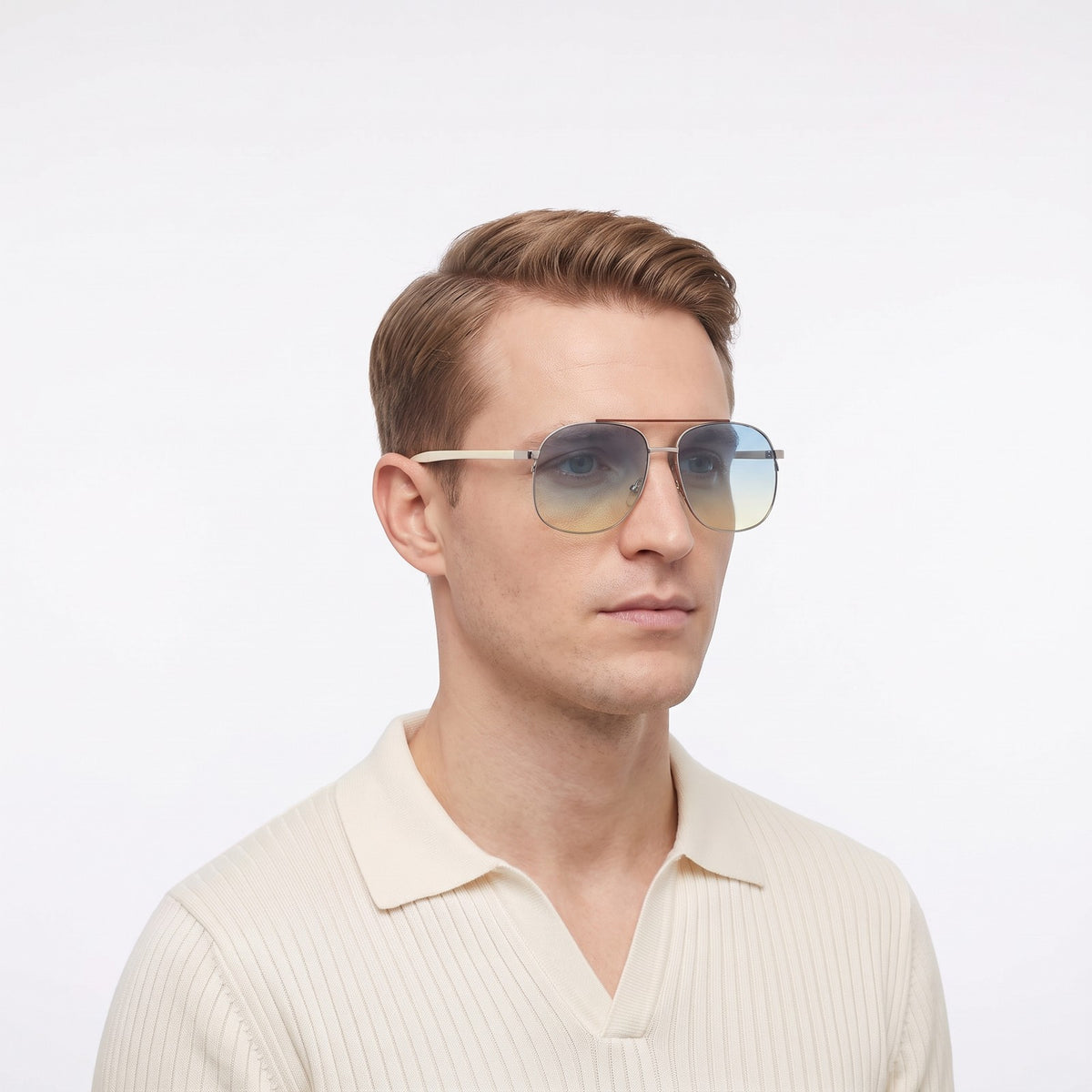 Man in a cream knit polo wearing Dubai aviator sunglasses with silver double bridge and blue-to-yellow gradient lenses — Velezeco #opt1_7