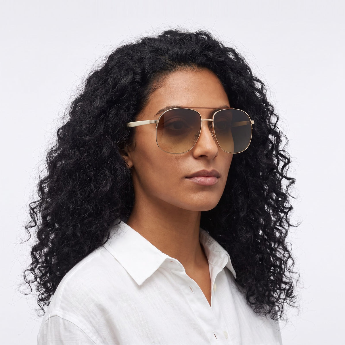 Woman in a white linen shirt wearing Dubai aviator sunglasses with gold double bridge and gradient brown lenses — Velezeco #opt1_6