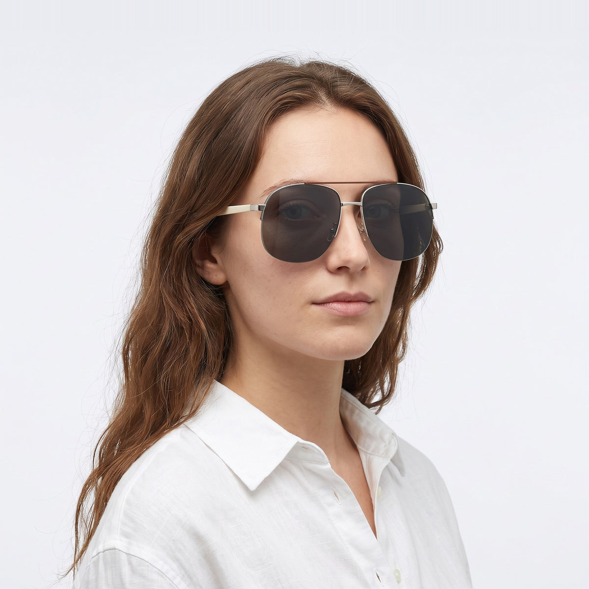 Woman in a white linen shirt wearing Dubai aviator sunglasses with silver double bridge and dark grey lenses — Velezeco #opt1_1