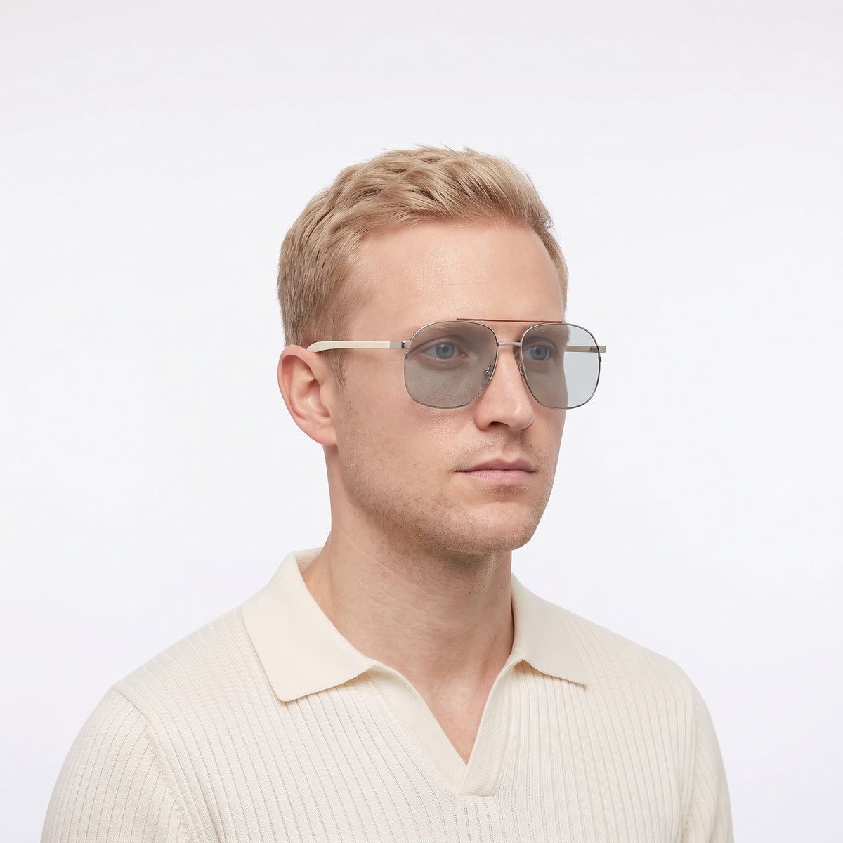 Man in a cream knit polo wearing Dubai aviator sunglasses with silver double bridge and light grey lenses — Velezeco #opt1_3