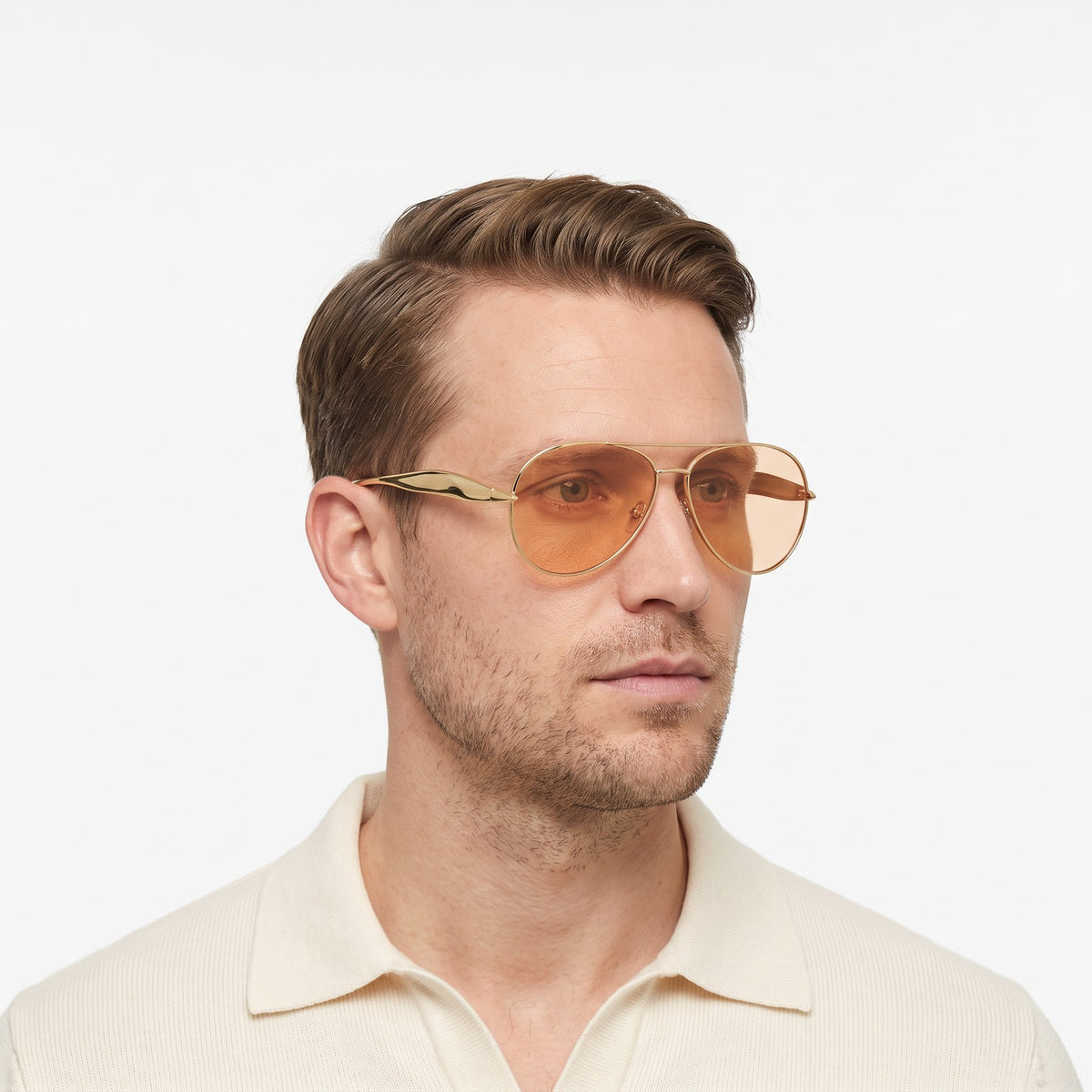 Man in a cream knit polo wearing Duna gold aviator sunglasses with orange lenses · Velezeco #opt1_5