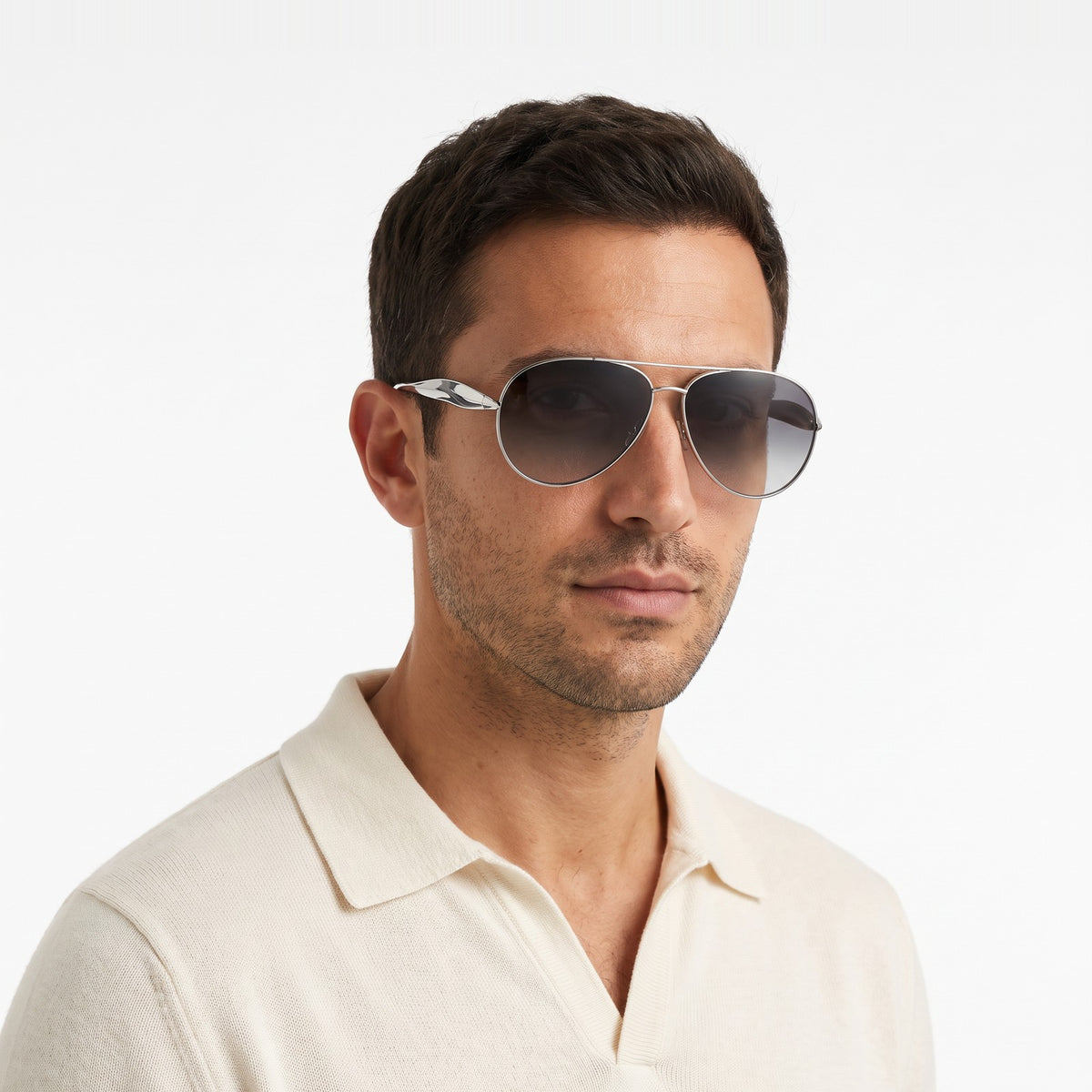 Man in a cream knit polo wearing Duna silver aviator sunglasses with grey gradient lenses · Velezeco #opt1_1