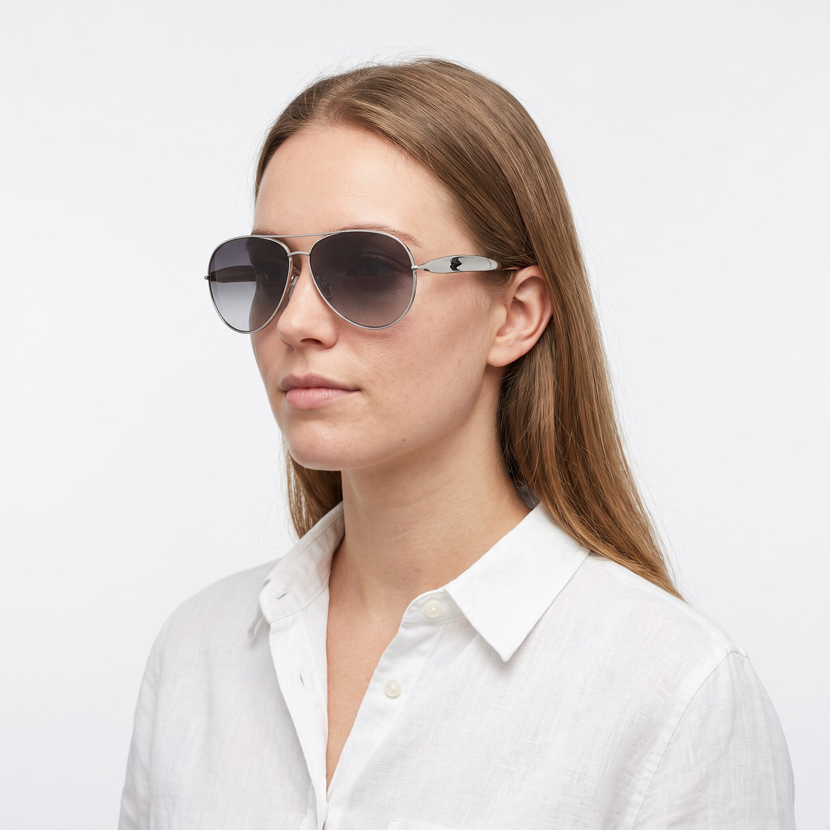 Woman in a white linen shirt wearing Duna silver aviator sunglasses with grey gradient lenses · Velezeco #opt1_1