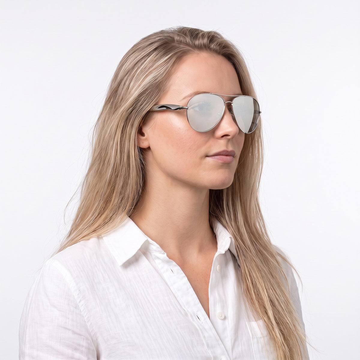 Woman in a white linen shirt wearing Duna silver aviator sunglasses with silver mirror lenses · Velezeco #opt1_7