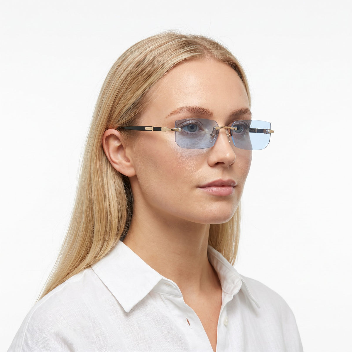Woman in a white linen shirt wearing Hills rimless rectangular sunglasses with light blue lenses · Velezeco #opt1_2