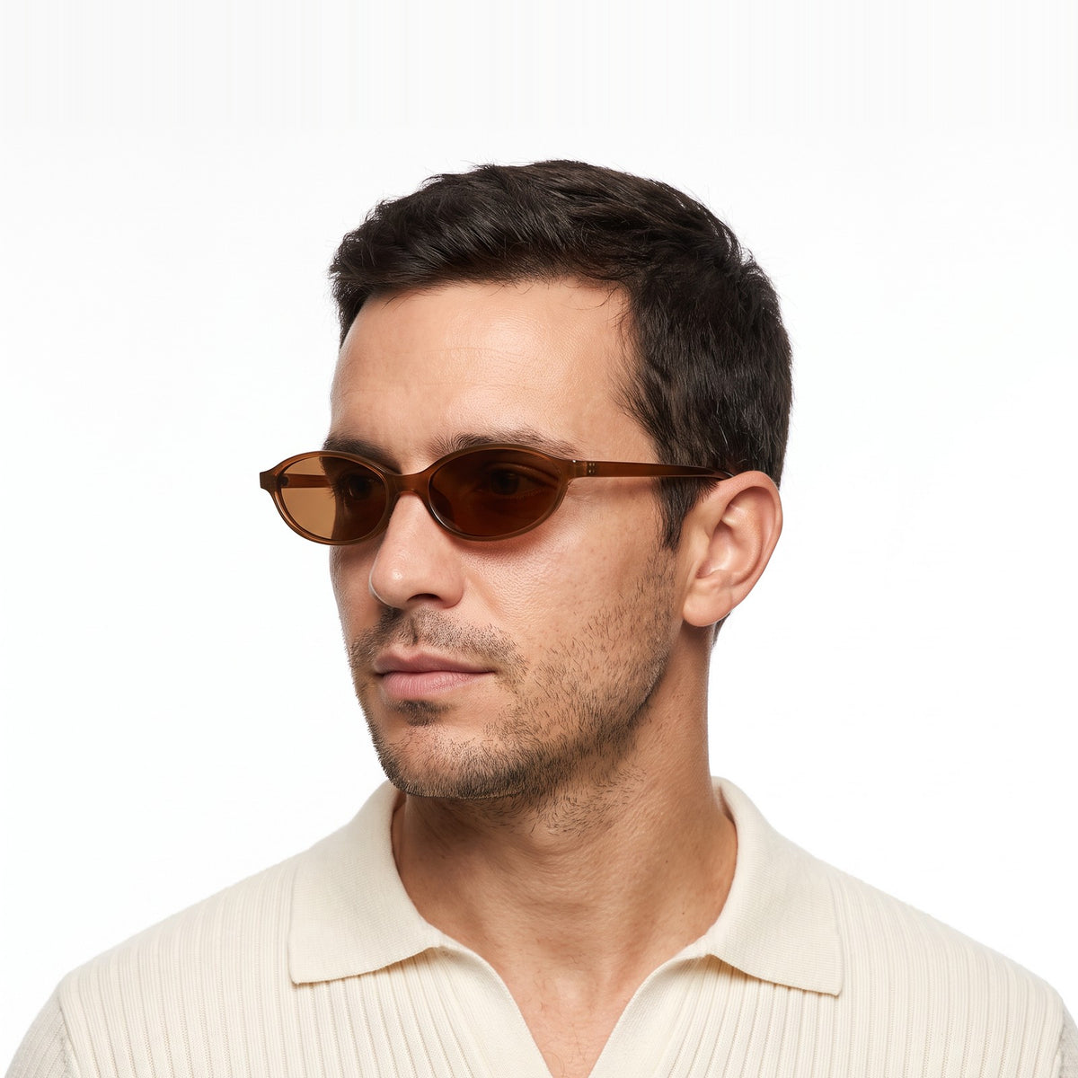 Man in a cream knit polo wearing Malibu slim oval translucent brown sunglasses with brown lenses · Velezeco #opt1_3