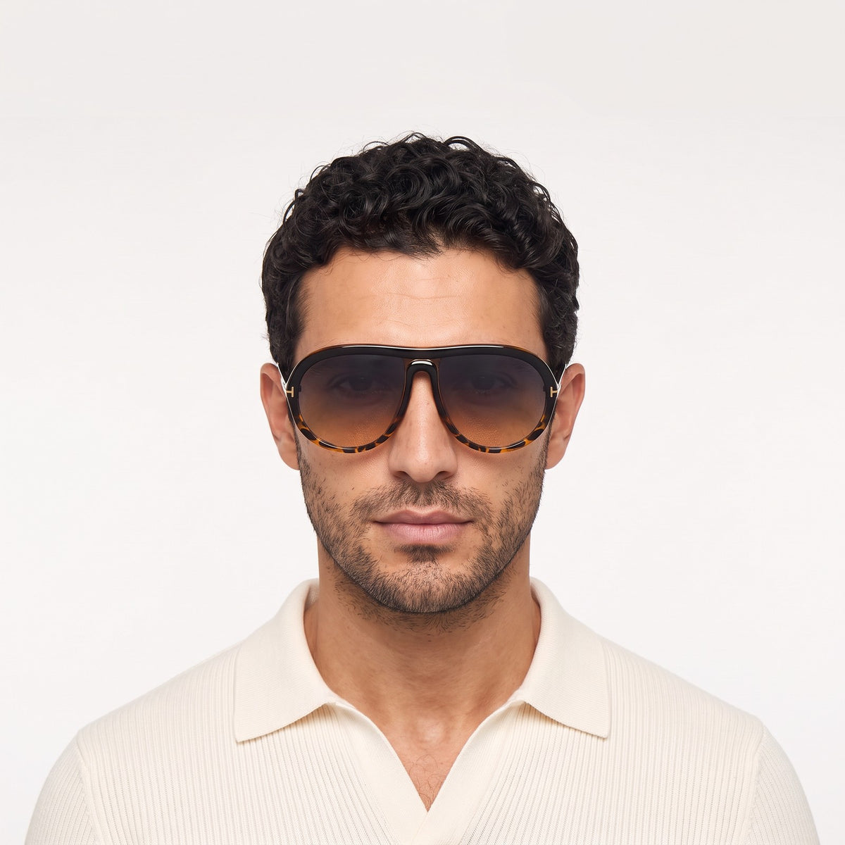 Man in a cream knit polo wearing Marbella black and leopard aviator sunglasses with gradient lenses · Velezeco #opt1_5