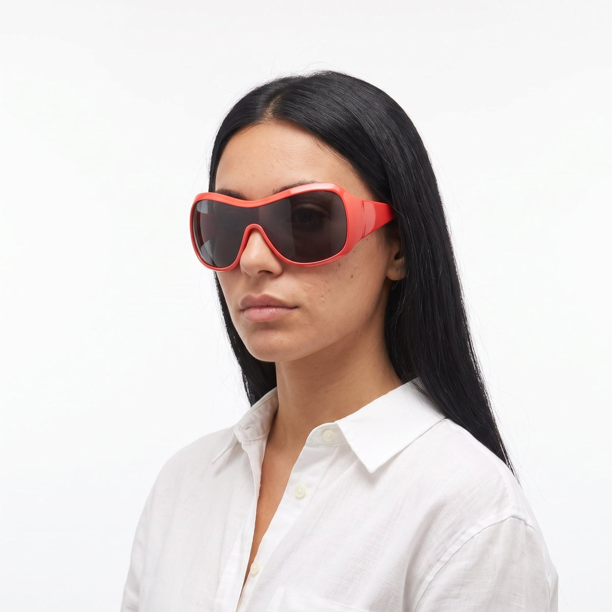 Woman in a white linen shirt wearing Miami wrap shield sunglasses with coral red frame and grey lens — Velezeco #opt1_2