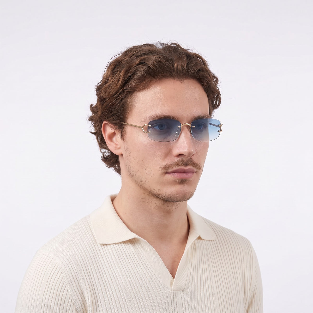Man in a cream knit polo wearing Moritz rimless sunglasses with gold metal details and gradient blue lenses — Velezeco #opt1_4
