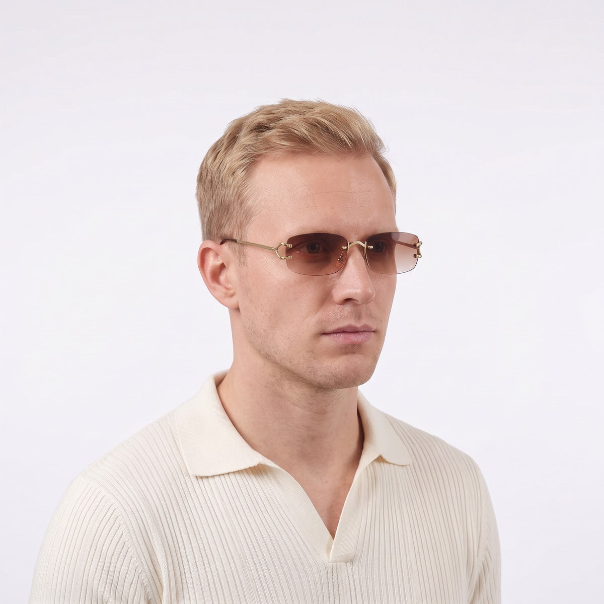 Man in a cream knit polo wearing Moritz rimless sunglasses with gold metal details and gradient brown lenses — Velezeco #opt1_2