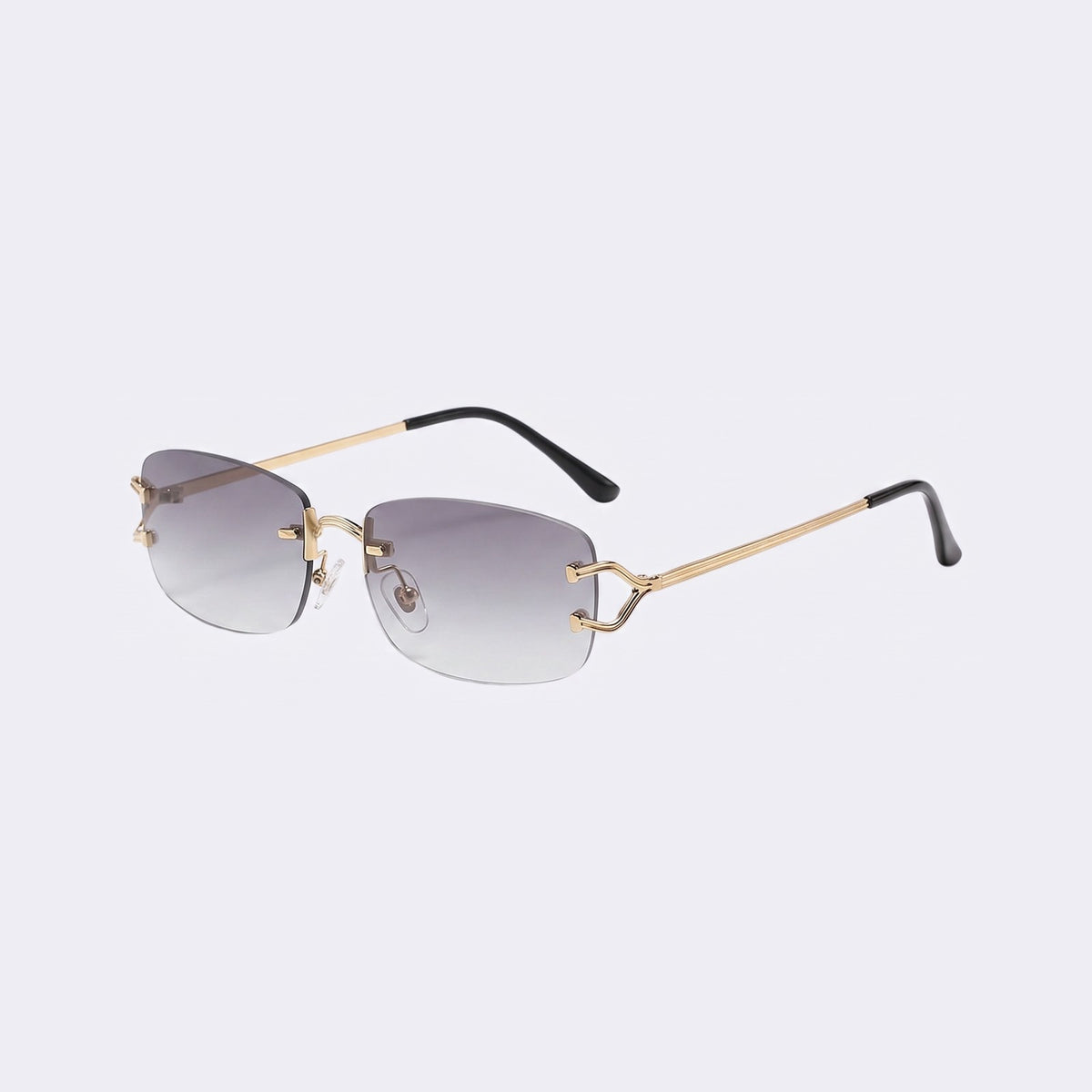 Three-quarter view of the rimless Moritz with gold metal details and gradient grey lenses showing the sculpted gold hinge — Velezeco #opt1_3