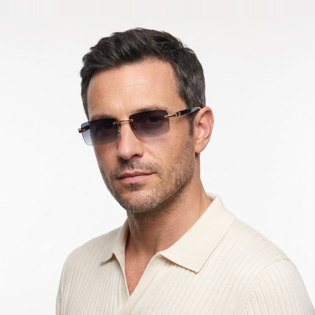 Man in a cream knit polo wearing Phantom rimless sunglasses with grey gradient lenses and black temples · Velezeco #opt1_1