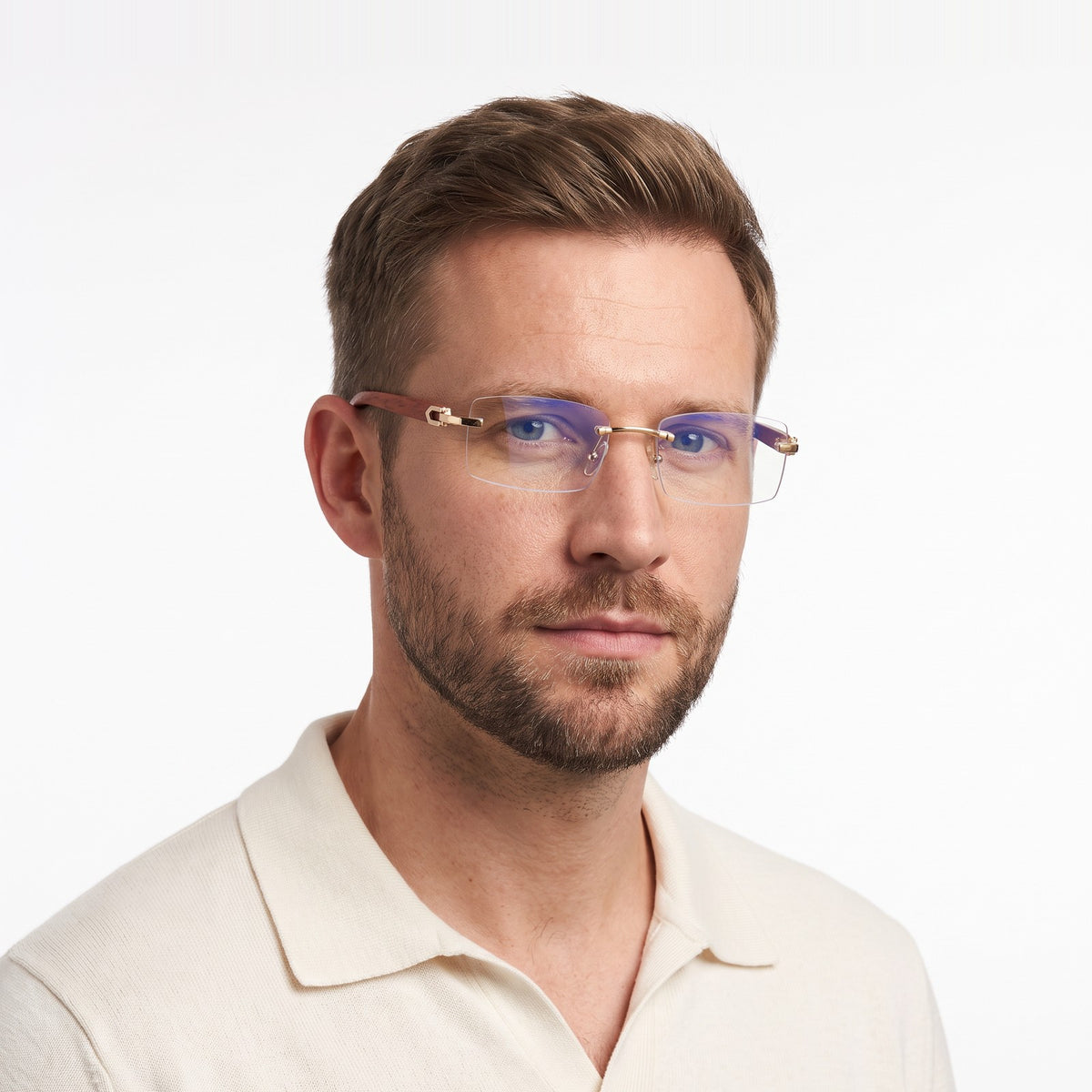 Man in a cream knit polo wearing Phantom rimless blue light glasses with clear lenses and wood-grain temples · Velezeco #opt1_3