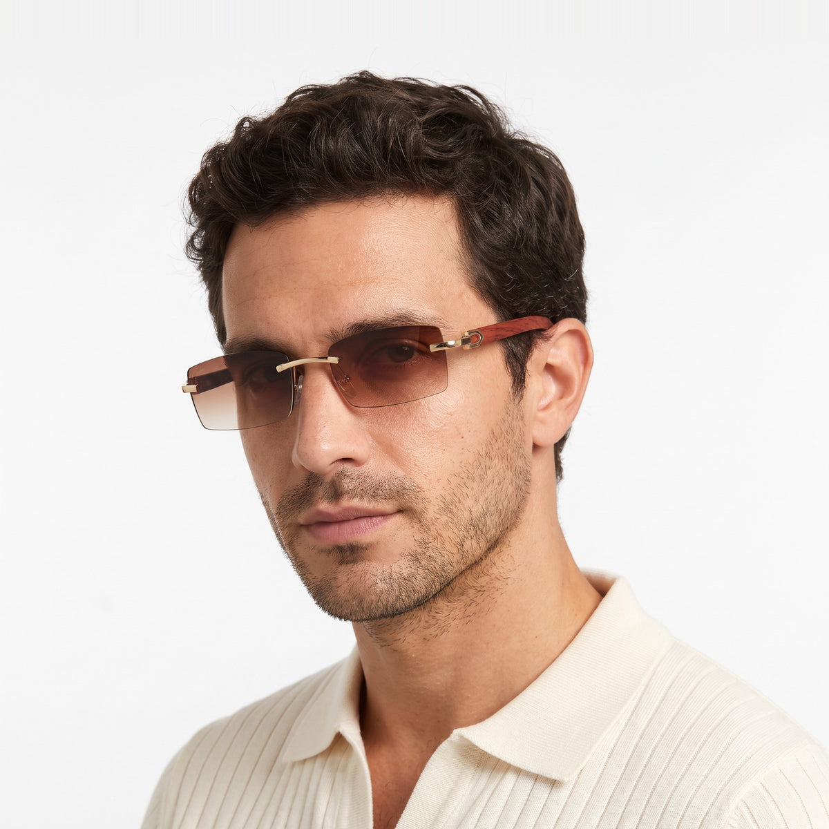 Man in a cream knit polo wearing Phantom rimless sunglasses with brown gradient lenses and wood-grain temples · Velezeco #opt1_2
