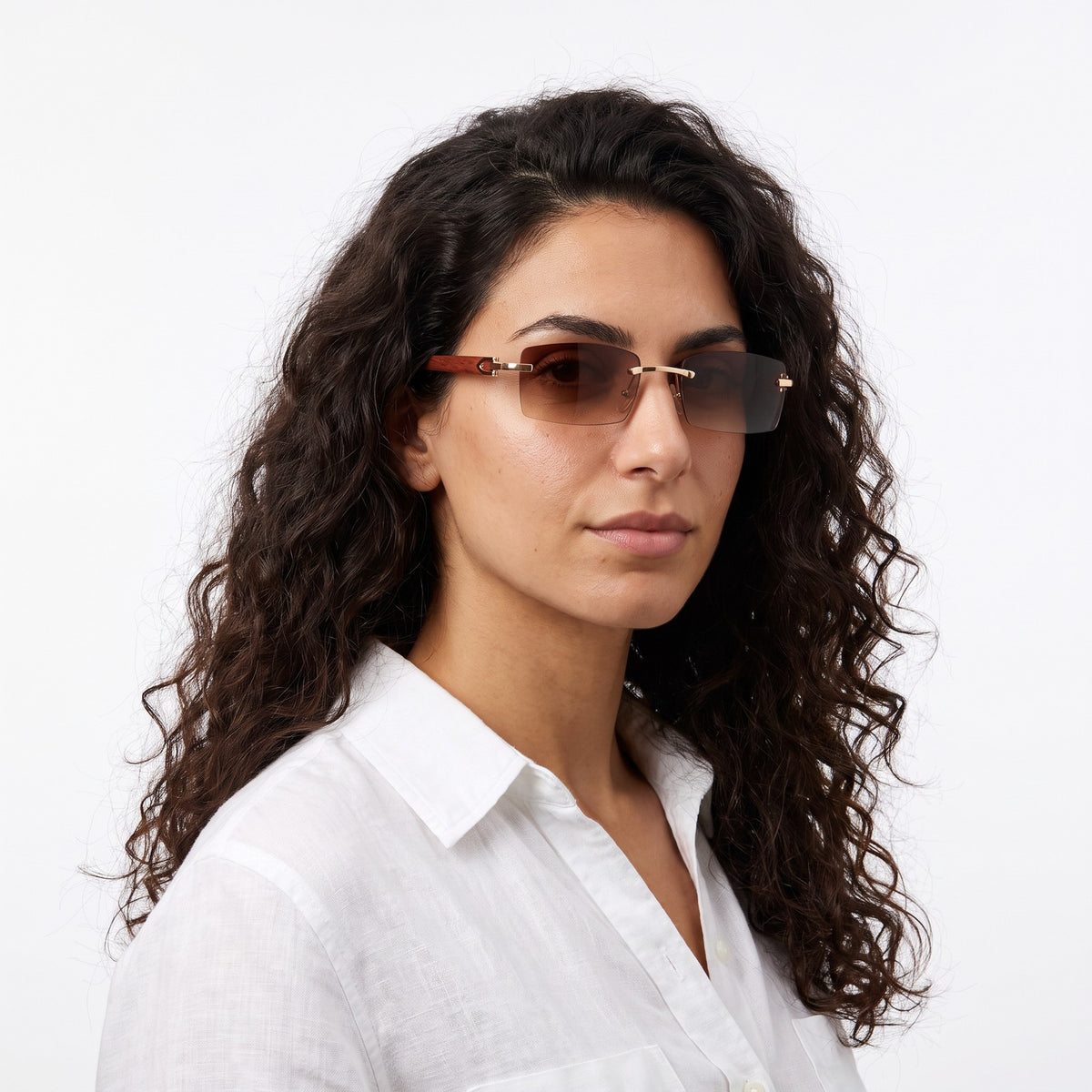 Woman in a white linen shirt wearing Phantom rimless sunglasses with brown gradient lenses and wood-grain temples · Velezeco #opt1_2