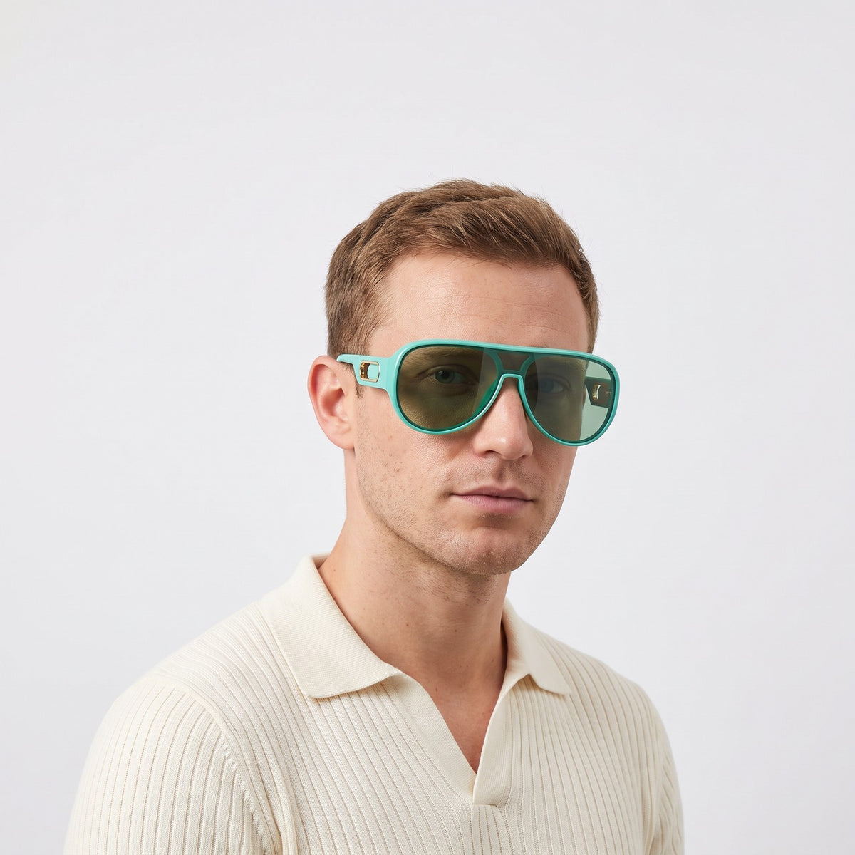 Man in a cream knit polo wearing Portofino shield sunglasses with aqua turquoise frame and green lens — Velezeco #opt1_2