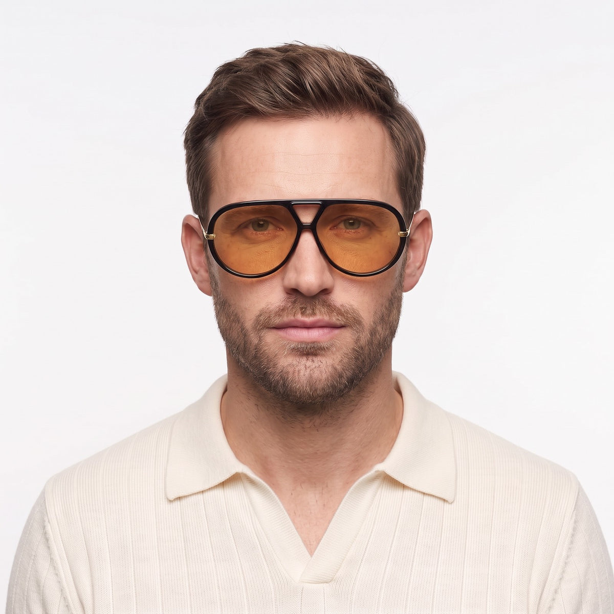 Man in a cream knit polo wearing The Aether black aviator sunglasses with orange lenses · Velezeco #opt1_2