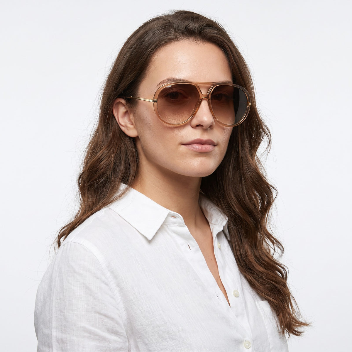 Woman in a white linen shirt wearing The Aether champagne aviator sunglasses with brown gradient lenses · Velezeco #opt1_6